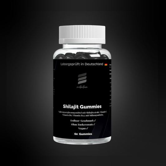 Transparente Dose mit schwarzen Shilajit-Gummies, schwarzes Etikett mit Aufdruck „Laborgeprüft in Deutschland“, Markenlogo, Produktname, Erdbeer-Geschmack, ohne Zuckerzusatz, vegan; 60 Gummies sichtbar im Inneren.